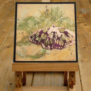 Parts of the butterfly lino print have been gilded with Copper leaf.