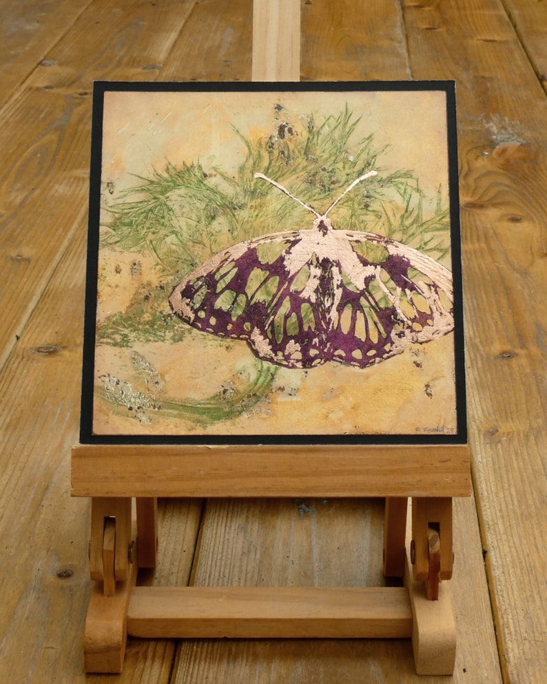 Parts of the butterfly lino print have been gilded with Copper leaf.
