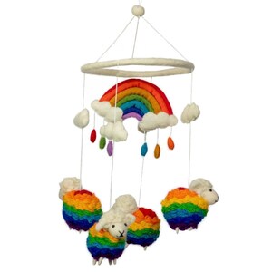 May include: A whimsical baby mobile featuring a rainbow, fluffy white clouds, and colorful raindrops. Below the rainbow are four sheep with rainbow-colored wool. The mobile is suspended from a white ring and string.