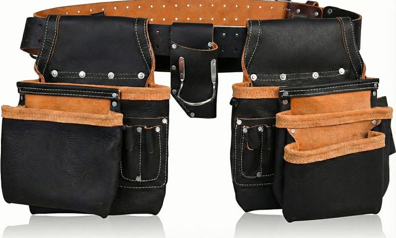 May include: A black leather tool belt with multiple pockets and pouches. The belt has a brown leather trim and a sturdy buckle. The pockets are reinforced with rivets and white stitching. The belt is designed for carrying tools.