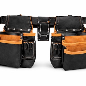May include: A black and tan leather tool belt with multiple pockets and pouches. The belt has a silver buckle and rivets. The interior of the pockets is tan, and the exterior is black. The tool belt is designed for construction or carpentry.