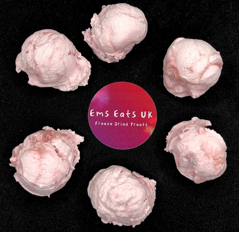 May include: Six pink freeze-dried ice cream scoops on a black background. The label reads "Ems Eats UK Freeze Dried Treats".