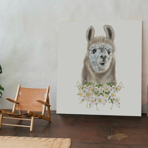 May include: A white canvas print featuring a close-up portrait of a llama with white flowers around its neck. The llama has brown fur and a white face. The background is white.
