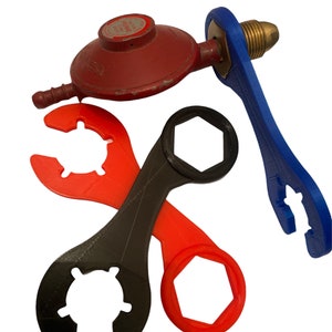May include: An assortment of tools, including a red propane regulator and several wrenches in black, red, and blue. The wrenches have various shapes, including a hexagonal opening and curved ends for gripping.