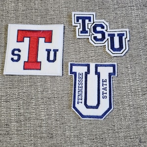 May include: Four embroidered patches featuring the letters "TSU" and "Tennessee State University". The patches are white with blue and red accents. One patch is square, while the others are shaped to fit the letters.