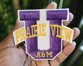 May include: Purple and gold embroidered patch with the text "Prairie View A&M" and a large purple "U" in the centre.