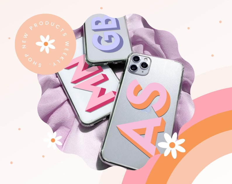May include: Clear phone cases with colourful 3D letter designs. The letters are pink, orange, and purple. The image also includes the text "NEW PRODUCTS WEEKLY SHOP". The background has a pink and orange rainbow.