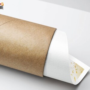 May include: A rolled up print with a white background and a pattern of small gold dots. The print is being unrolled from a brown cardboard tube.