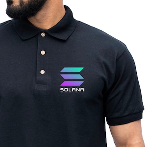 May include: Black polo shirt with a colorful logo that says "SOLANA" on the left chest.
