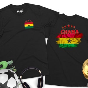 May include: Two black t-shirts with a red, yellow, green, and black flag design. The flag has a black star in the center and the word "GHANA" printed above it. One shirt has a smaller version of the flag in the upper left corner.