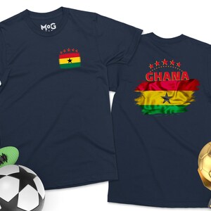 May include: Two navy blue t-shirts with a red, yellow, green, and black flag design. The flag has a black star in the center and the word "GHANA" in red letters. One shirt has a smaller version of the flag on the left chest.