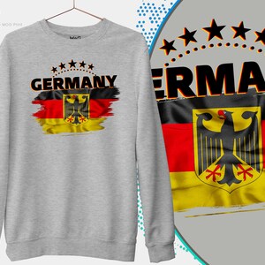 May include: A gray sweatshirt with a distressed German flag design and the word "GERMANY" printed in black. The flag features the German eagle and is surrounded by five stars.