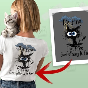 May include: A white t-shirt with a black cat graphic and the text "It's Fine I'm Fine Everything Is Fine". The cat is wearing a blue cloud with raindrops and lightning bolts.
