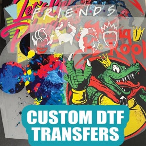 May include: Custom DTF transfers with various designs, including a cartoon crocodile wearing a crown and a red cape, and a set of cartoon characters with horns and crowns. The designs are on a clear sheet with a white background.