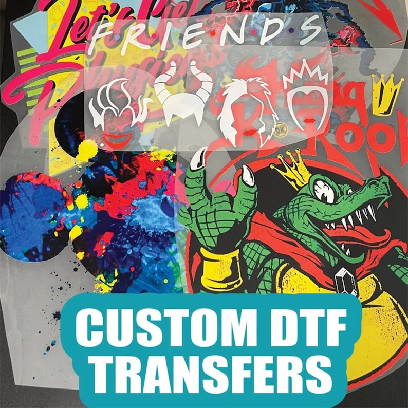 May include: Custom DTF transfers with various designs, including a cartoon crocodile wearing a crown and a red cape, and a set of cartoon characters with horns and crowns. The designs are on a clear sheet with a white background.
