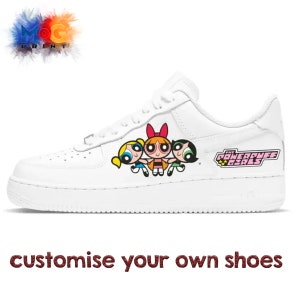May include: White sneakers with a graphic of the Powerpuff Girls, Blossom, Bubbles, and Buttercup, with the text "The Powerpuff Girls" on the side.