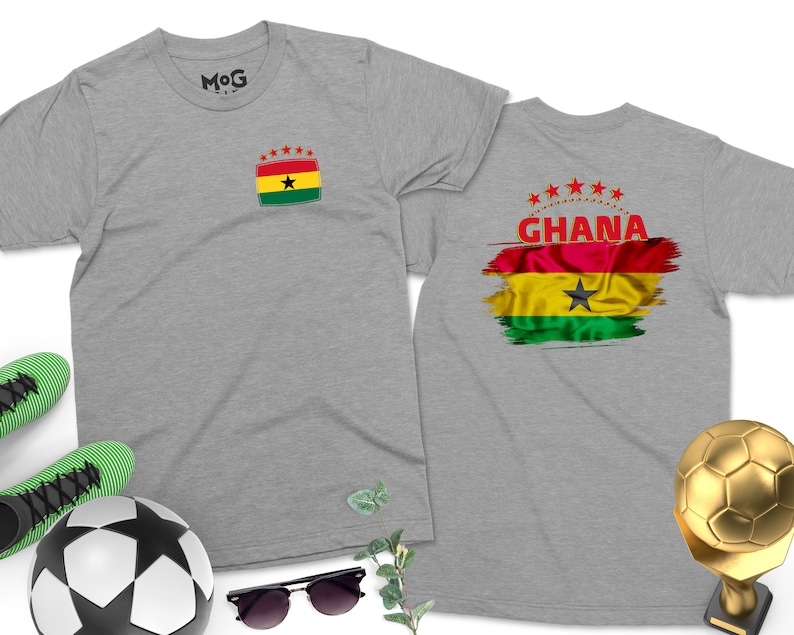 May include: Two gray t-shirts with a Ghanaian flag design. One shirt has a small flag on the front and the other has a larger flag with the word "GHANA" on the back.