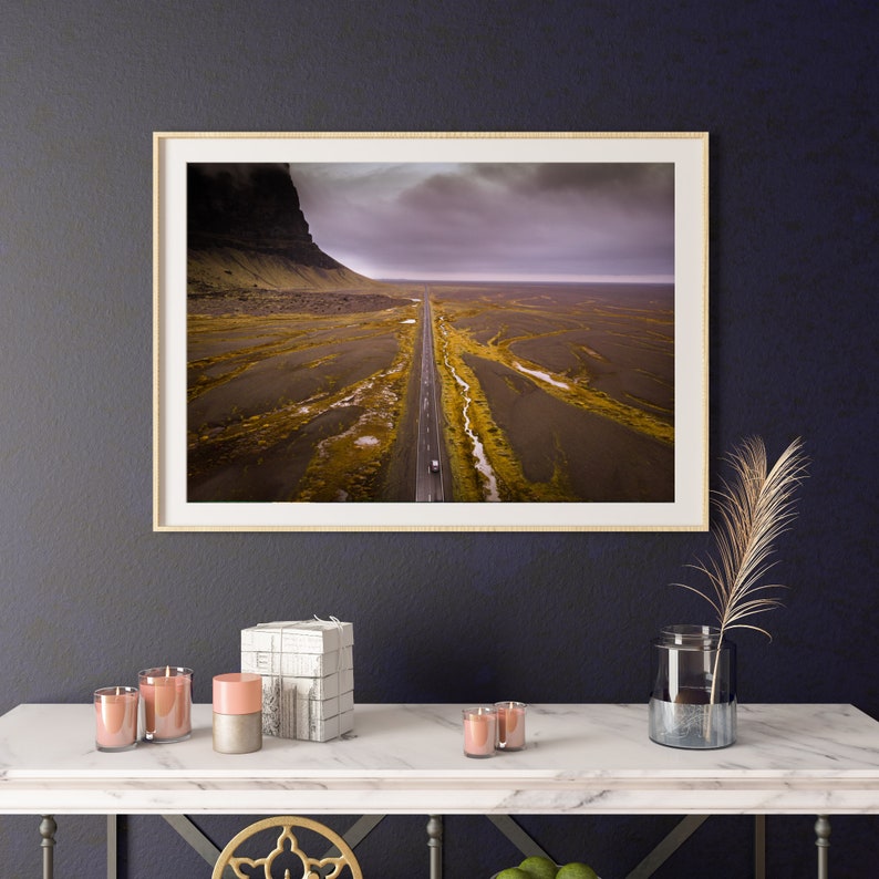 A framed photographic print of a birds eye view of a remote road in Iceland.