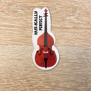 May include: A white sticker with a black outline of a double bass and the text "BASS-ICALLY PERFECT".