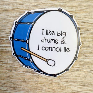 May include: A sticker depicting a blue and white drum with a drumstick. The text on the drum reads, "I like big drums & I cannot lie."