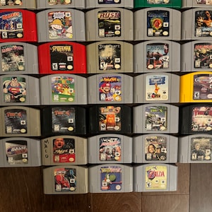 May include: A collection of 20 Nintendo 64 game cartridges, including titles like "Spiderman", "Starcraft", "Super Mario 64", "Smash Bros", "Zelda", "WCW vs. nWo", and "Turok".