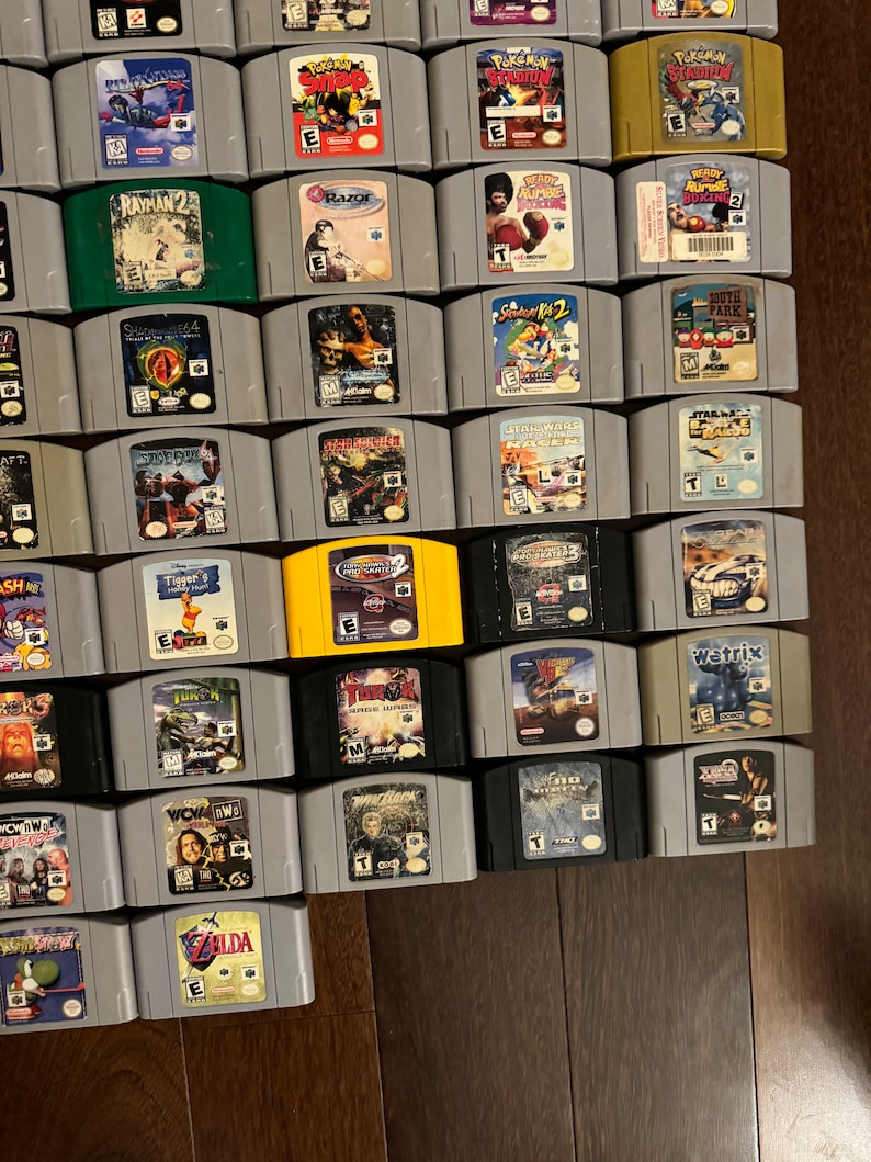 May include: A collection of 30 Nintendo 64 video game cartridges, including titles like "Rayman 2", "Star Wars: Rogue Squadron", "South Park", "Turok", and "Zelda: Ocarina of Time".