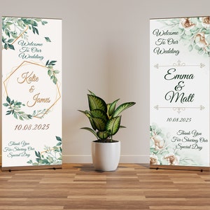 May include: Two wedding welcome signs with floral and geometric designs. One sign features "Katie & James" and the date "10.08.2025". The other sign displays "Emma & Matt" and the same date. Both signs include the text "Welcome To Our Wedding" and "Thank You For Sharing Our Special Day".