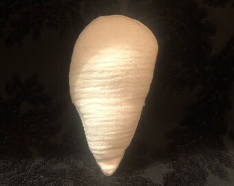 May include: White fabric cone-shaped cushion with a textured surface.