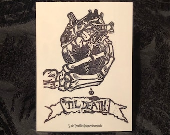 May include: Black and white illustration of a skeletal hand holding a heart with a banner that reads "Til Death". The artist's signature is below the banner.