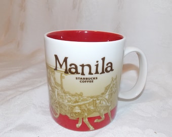 May include: White ceramic mug with a red interior and a brown and gold image of a horse-drawn carriage. The mug has the text "Manila" and "Starbucks Coffee" printed on it.