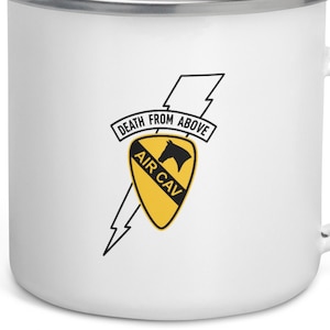 May include: White enamel mug with a black and yellow graphic of the 101st Airborne Division's insignia, featuring a horse's head and the text "Death from Above" and "Air Cav".