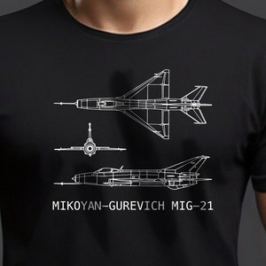 May include: A black t-shirt with a white outline of a Mikoyan-Gurevich MiG-21 jet fighter. The design includes three different views of the aircraft.