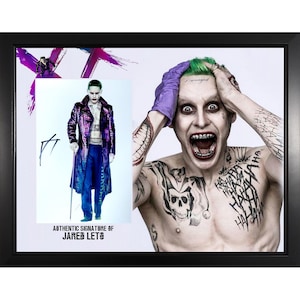 May include: Framed print featuring two images of a character with green hair and tattoos. One image shows the character in a purple coat and blue pants, the other shows the character with an open mouth and purple gloves. The text "AUTHENTIC SIGNATURE OF JARED LETO" is visible.