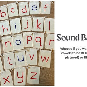 May include: A collection of small, off-white drawstring bags, each displaying a letter of the alphabet in either red or blue. The vowels are blue, as pictured. The text "Sound Bags" is also visible.