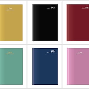 May include: Six hardcover 2026 week-to-view planners in various colours. The colours include gold, black, burgundy, teal, navy blue, and pink. The year and "Week to View" are printed on the cover in a light colour.