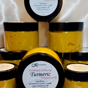May include: Multiple jars of turmeric whipped scrub, a natural exfoliating product. The jars are labeled "Foaming Exfoliating Turmeric Whipped Scrub" and list the ingredients: Granulated Crystals, Castille Soap, Vitamin E Oil, Premium Oil Blend. The label also states "Turmeric can stain clothes." and "4oz."