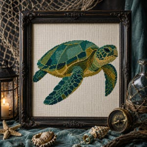 May include: A cross-stitch embroidery of a sea turtle in shades of teal, green, and yellow, displayed within a dark, ornate, rectangular wooden frame. The turtle is depicted in profile, showcasing a detailed shell pattern and flippers.