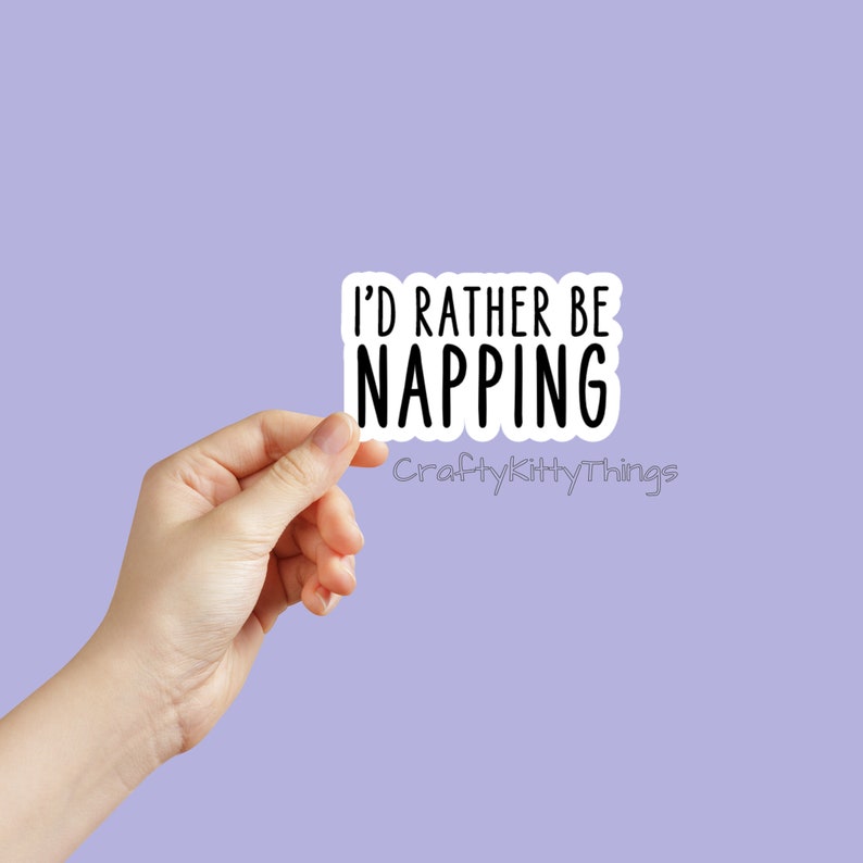 May include: White sticker with black text that reads "I'd rather be napping" with the words "CraftyKittyThings" below.