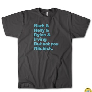 May include: Dark gray t-shirt with light blue text that reads "Mark & Helly & Dylan & Irving But not you Milchick."
