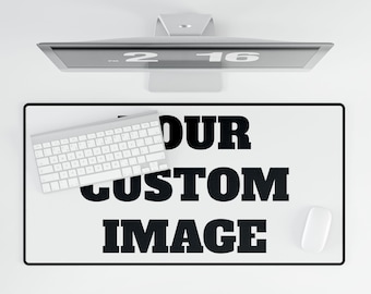 May include: A white desk mat with black text that reads "YOUR CUSTOM IMAGE". A white keyboard and mouse are on the mat.