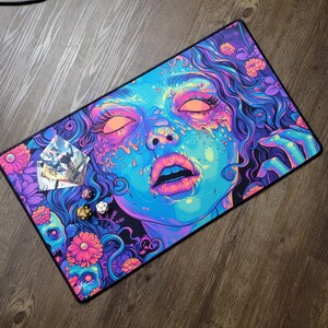 Beautiful zombie MTG playmat perfect for zombie Commander mtg card games. Pushing Up Daisies MTG Zombie Playmat & Gaming Desk mat with stitched edges comes in a large oversized mouse pad too. Perfect for any gamer accessories fitting a horror or psychedelic desk aesthetic. Its also a unique Dia De Los Muertos Playmat for tcg games. This is a black light reactive playmat.