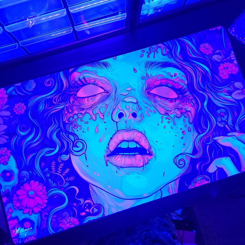 Beautiful zombie MTG playmat perfect for zombie Commander mtg card games. Pushing Up Daisies MTG Zombie Playmat & Gaming Desk mat with stitched edges comes in a large oversized mouse pad too. Perfect for any gamer accessories fitting a horror or psychedelic desk aesthetic. Its also a unique Dia De Los Muertos Playmat for tcg games. This is a black light reactive playmat.