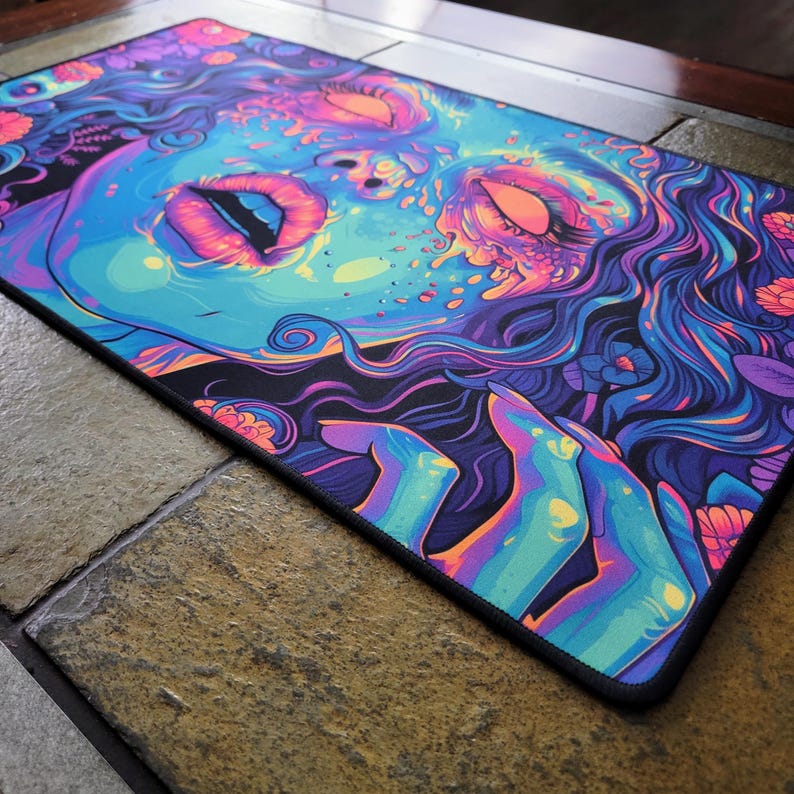 Beautiful zombie MTG playmat perfect for zombie Commander mtg card games. Pushing Up Daisies MTG Zombie Playmat & Gaming Desk mat with stitched edges comes in a large oversized mouse pad too. Perfect for any gamer accessories fitting a horror or psychedelic desk aesthetic. Its also a unique Dia De Los Muertos Playmat for tcg games. This is a black light reactive playmat.