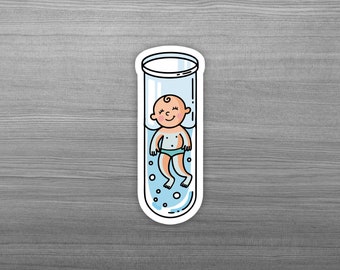 May include: A cartoon illustration of a baby floating in a test tube filled with blue liquid. The baby is wearing a blue diaper and has a happy expression.
