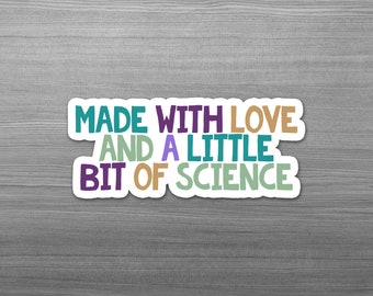 May include: A white sticker with the text "Made with love and a little bit of science" in colorful letters. The letters are in different colors, including purple, teal, green, and orange.
