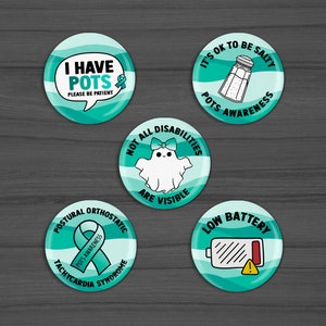May include: Five teal blue round buttons with white text and images. The buttons read: "I Have POTS Please Be Patient", "It's OK to Be Salty POTS Awareness", "Not All Disabilities Are Visible", "Postural Orthostatic Tachycardia Syndrome POTS Awareness", and "Low Battery".