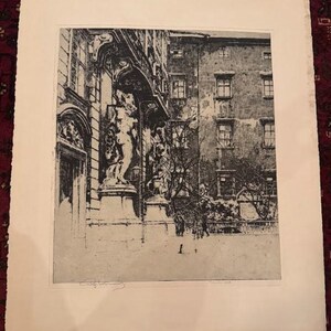 May include: Black and white architectural print depicting a building facade with statues and arched doorways. The print features detailed shading and a signature in the lower left corner. The artwork is mounted on a white paper.