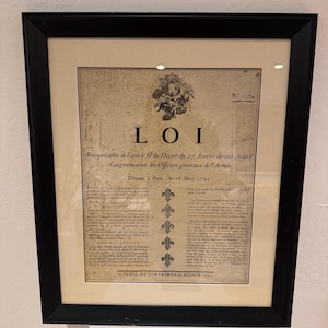 May include: Framed antique document with the word "LOI" at the top. The document is aged with visible wear and tear. The text includes the date "18 Mars 1793" and the phrase "A PARIS, DE L'IMPRIMERIE ROYALE 1793."