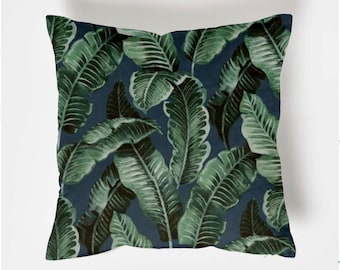 May include: A blue cushion with a green tropical leaf pattern.