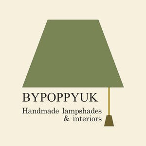 May include: A graphic logo featuring a trapezoidal olive green lampshade atop a thin gold stem and a brown base. The text BYPOPPYUK is displayed in black, followed by the text Handmade lampshades & interiors in a smaller black font.